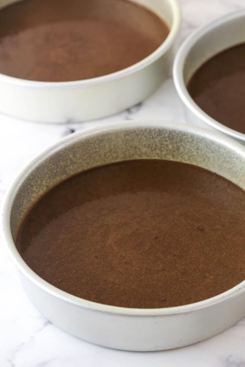 This peanut butter chocolate cake is made with layers of moist chocolate cake, peanut butter frosting and chopped Reese’s peanut butter cups. Chocolate cake batter divided between 3 cake pans.