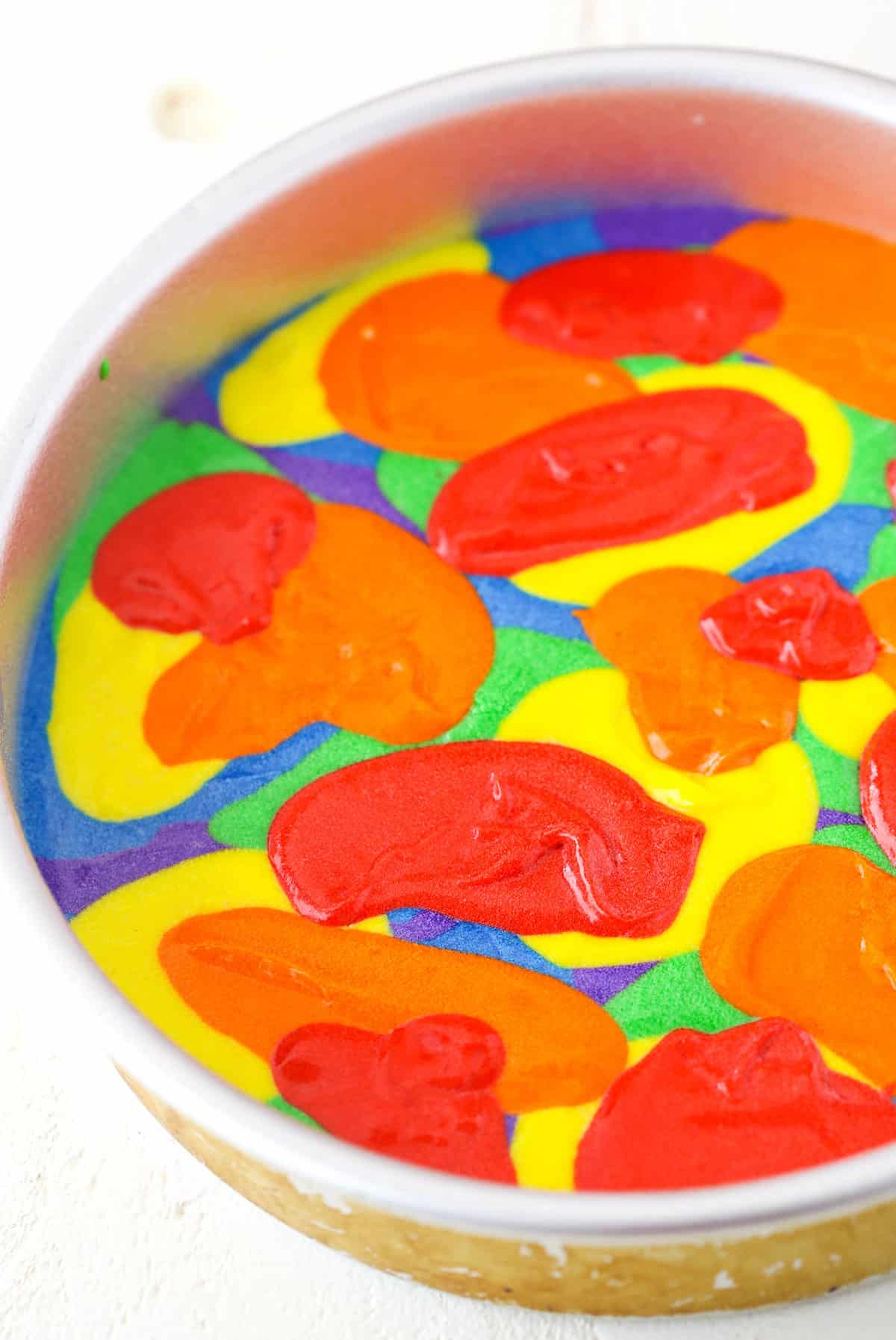 A step in making Rainbow Swirl Cake showing the layering of the cake batter to create the swirl effect