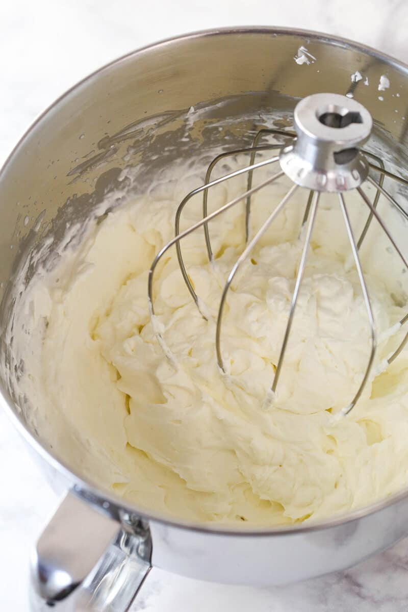 Whipped cream frosting in a mixing bowl.