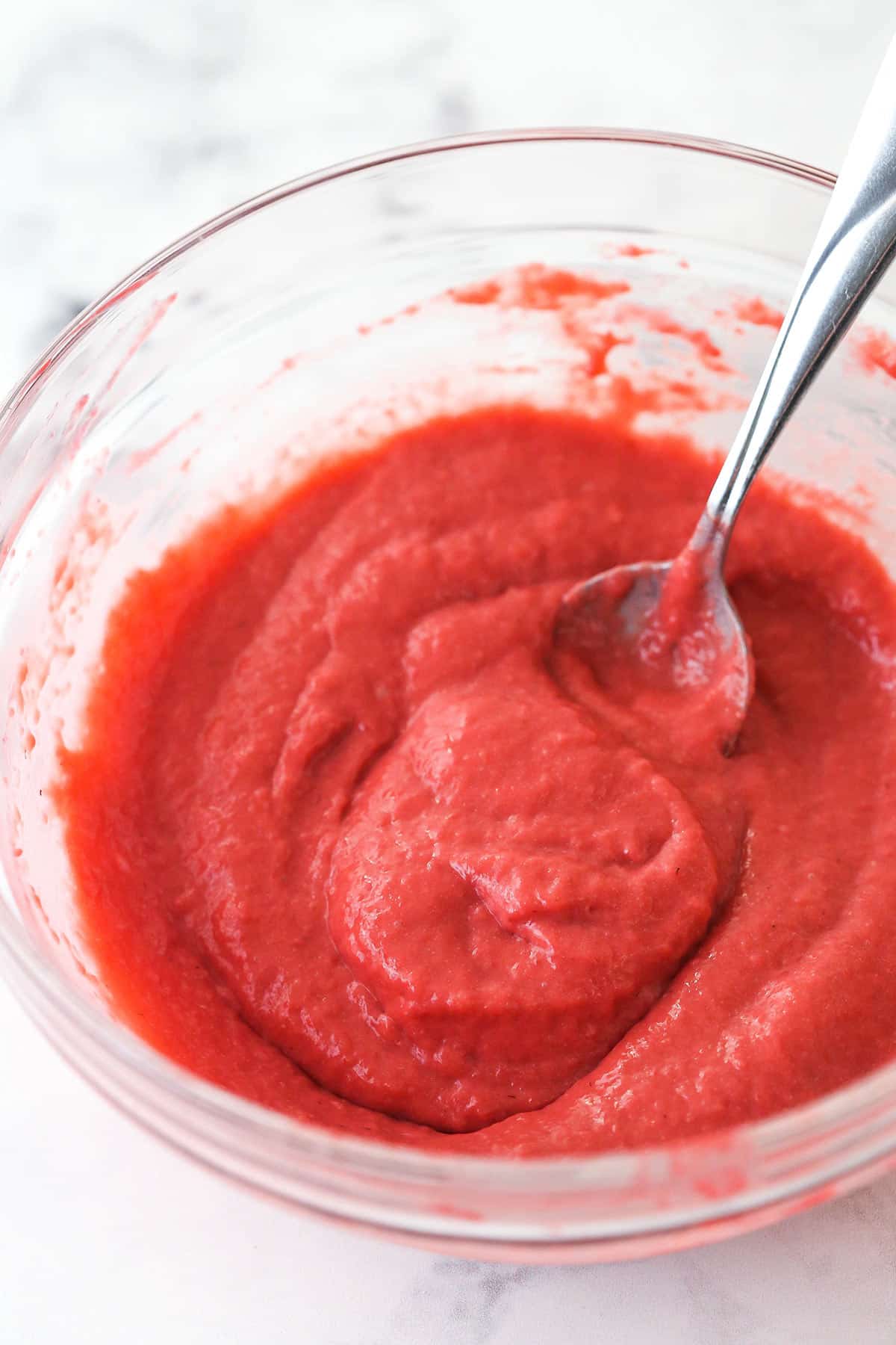 Strawberry filling for ice cream cake in a mixing bowl.