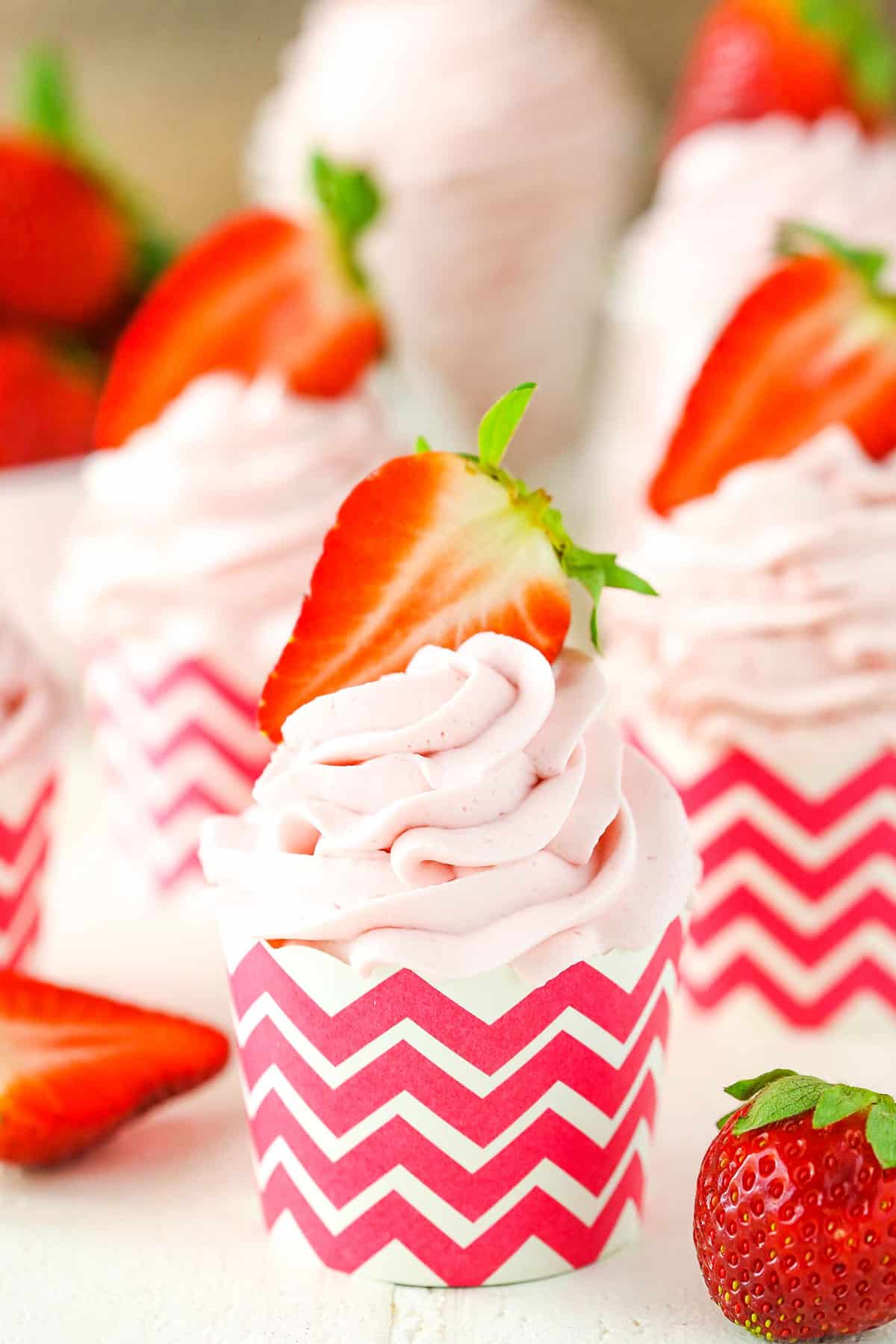 Homemade Strawberry Whipped Cream piped into a cupcake wrapper