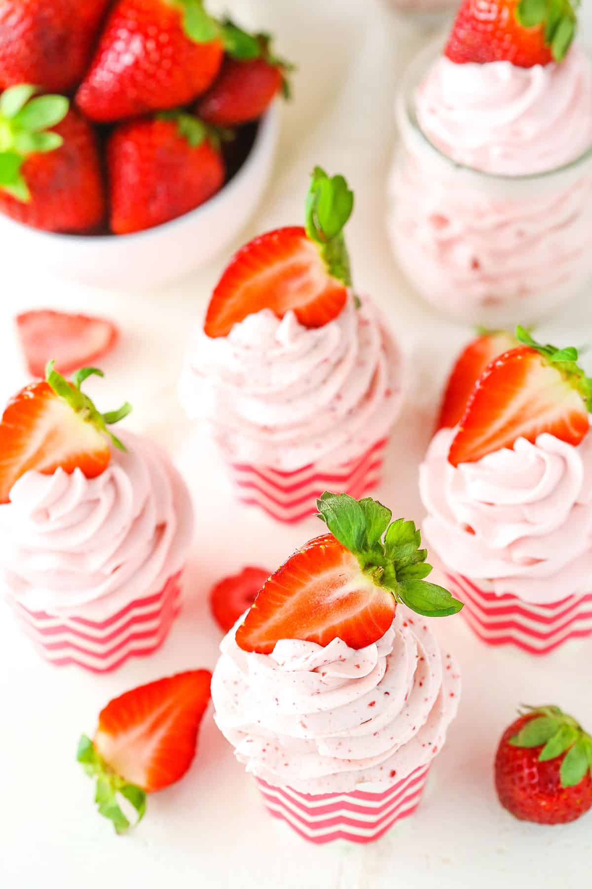 Homemade Strawberry Whipped Cream piped into cupcake wrappers