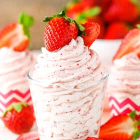 Homemade Strawberry Whipped Cream piped into a clear glass