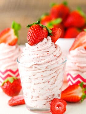 Homemade Strawberry Whipped Cream piped into a clear glass