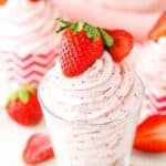 Homemade Strawberry Whipped Cream piped into a clear glass