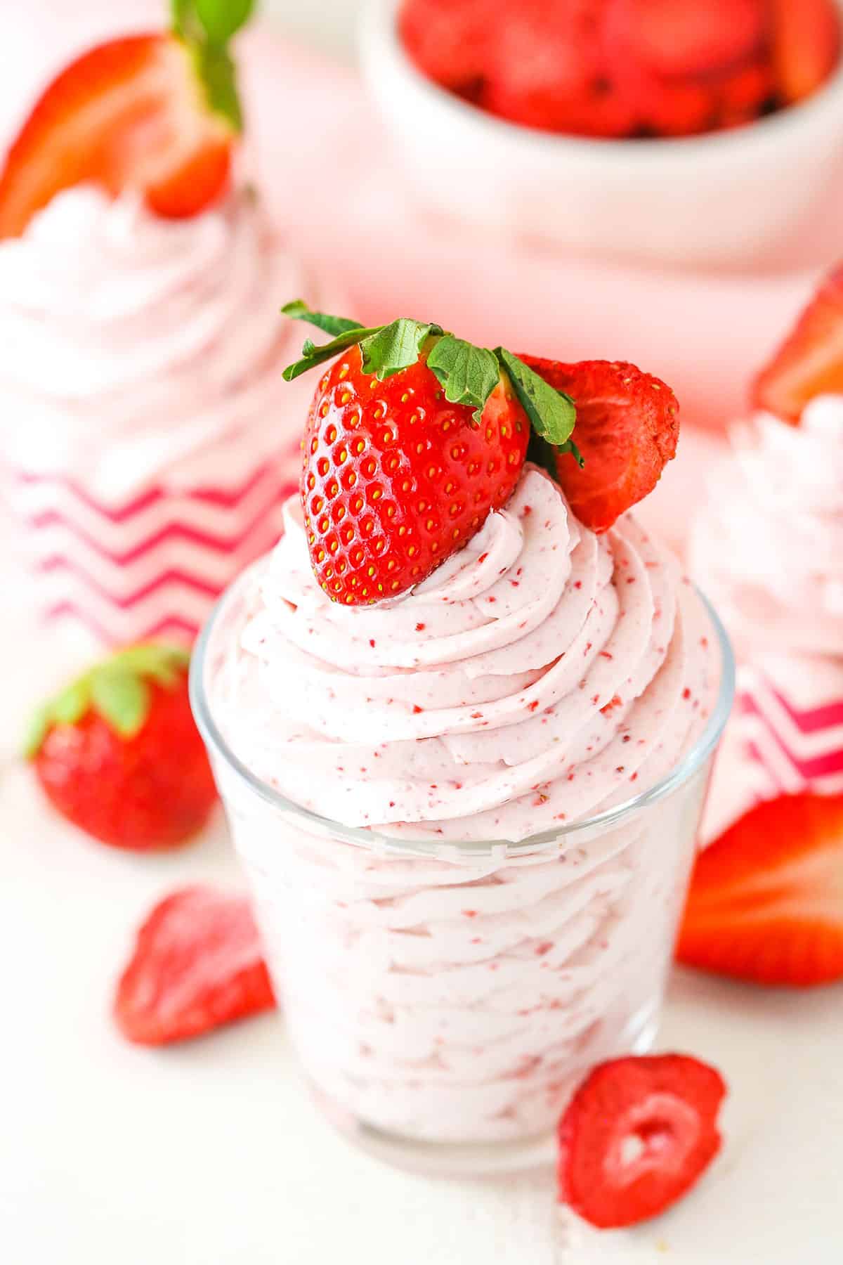 Homemade Strawberry Whipped Cream piped into a clear glass