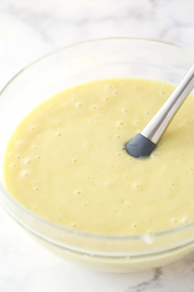 Mixing lemon cake batter with a rubber spatula.