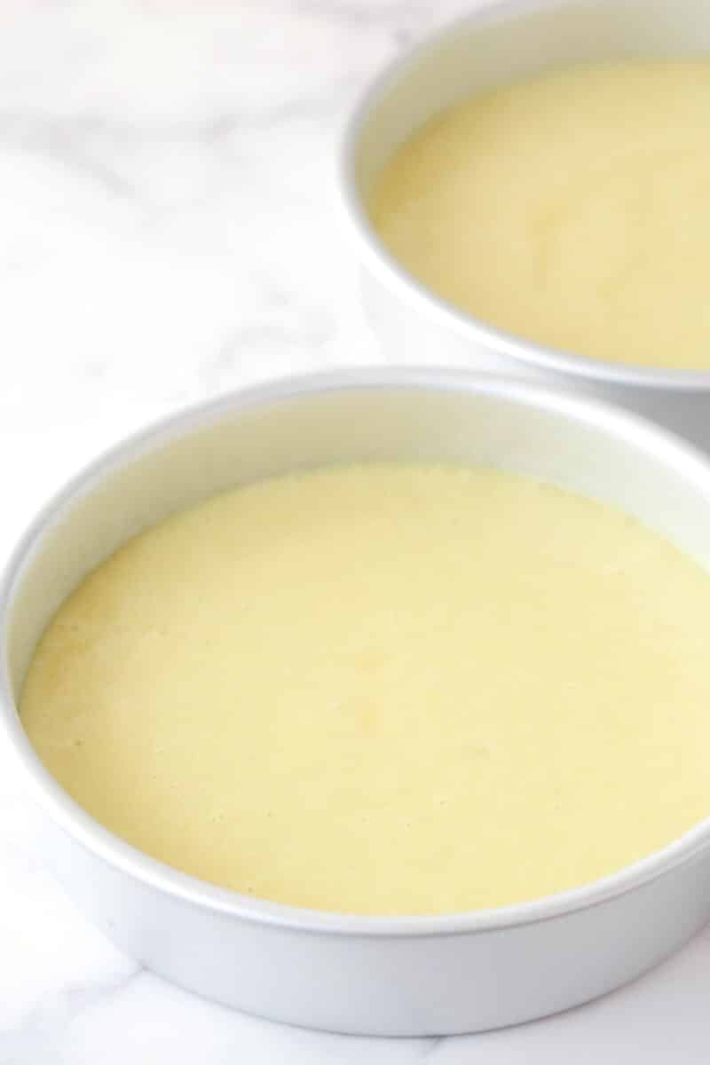 Lemon cake batter in 2 cake pans ready to be baked.