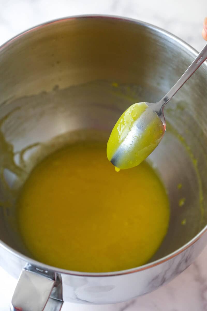 Lemon curd coating the back of a spoon.