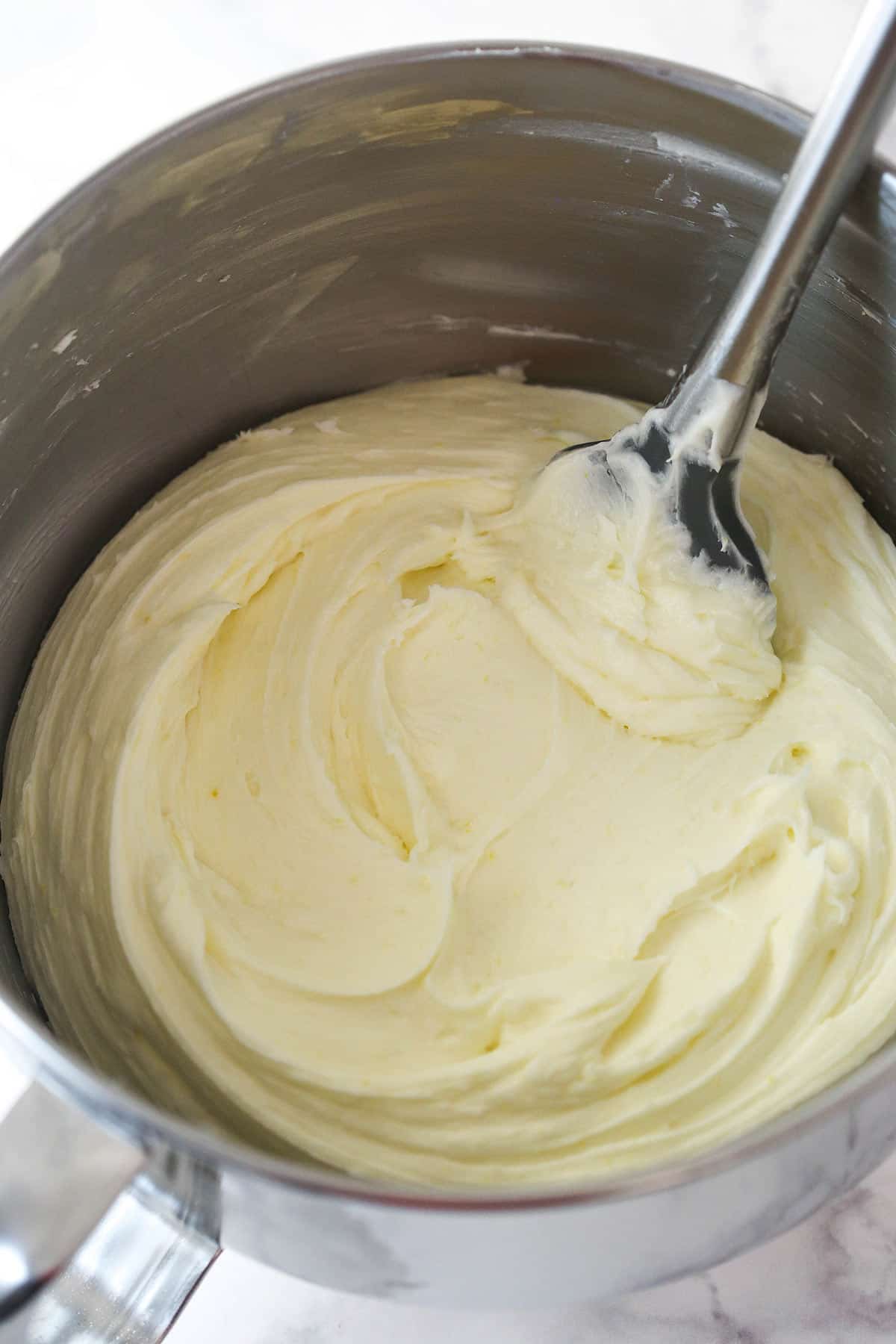 Lemon buttercream frosting in a mixing bowl.