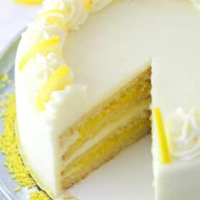 Overhead image of lemon curd cake with a slice taken out of it.