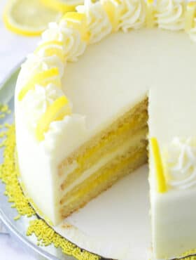 Overhead image of lemon curd cake with a slice taken out of it.