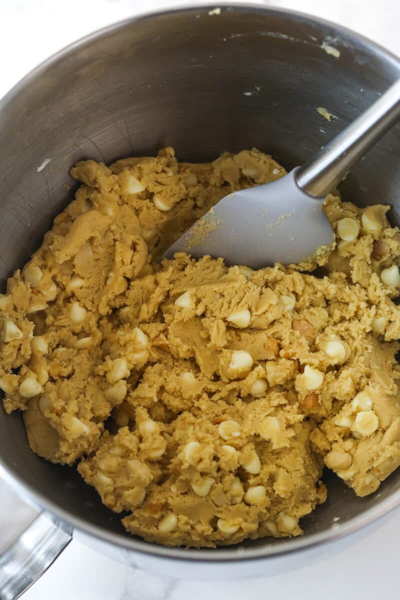 White chocolate macadamia nut cookie dough in a mixing bowl.