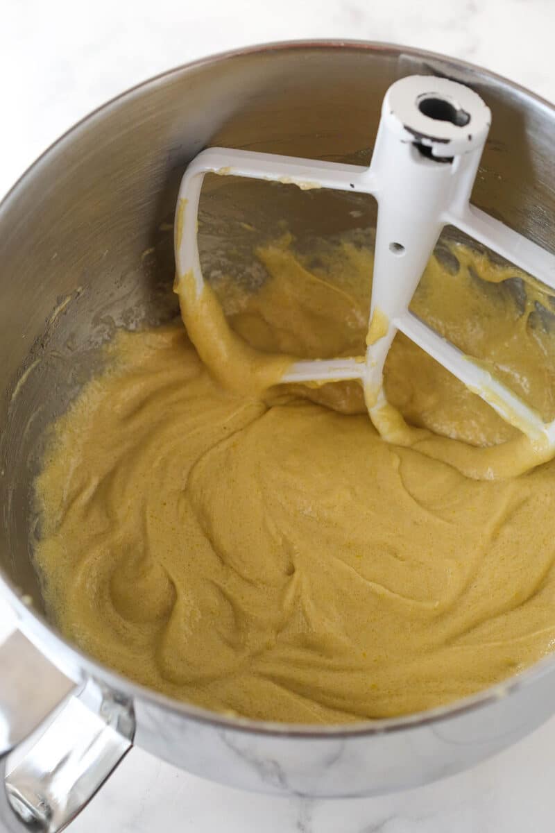 Mixing eggs into carrot cake batter.