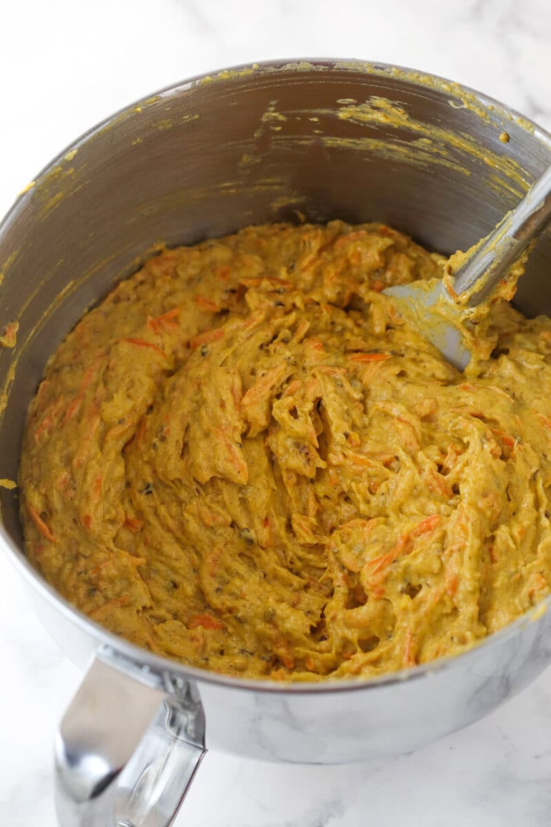 Adding mix-ins to carrot cake batter.