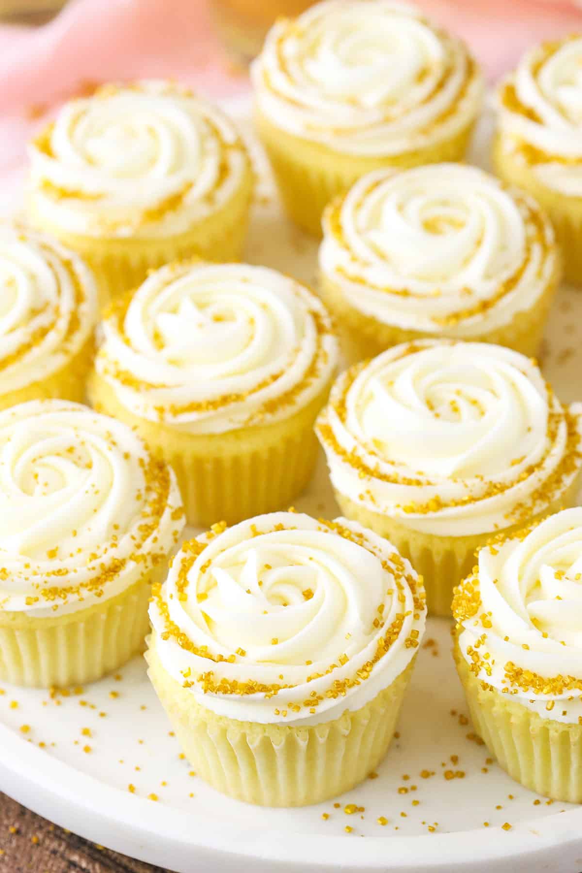 Champagne Cupcakes With Truffle Filling on a white cake stand