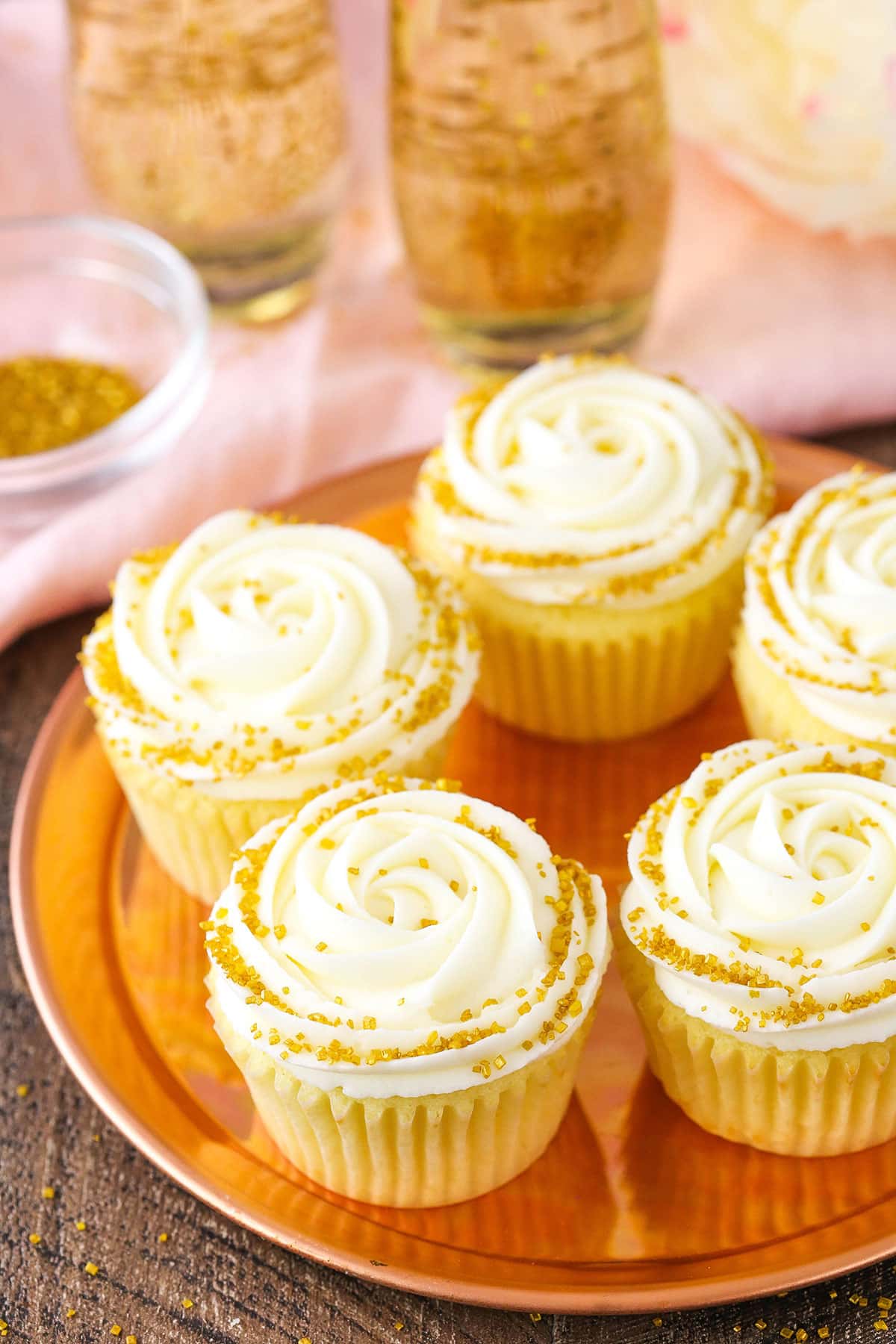 Overhead view of Champagne Cupcakes With Truffle Filling on a gold plate