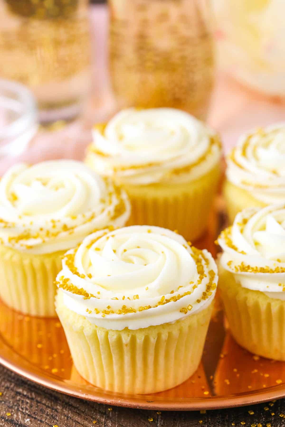 Overhead view of Champagne Cupcakes With Truffle Filling on a gold plate