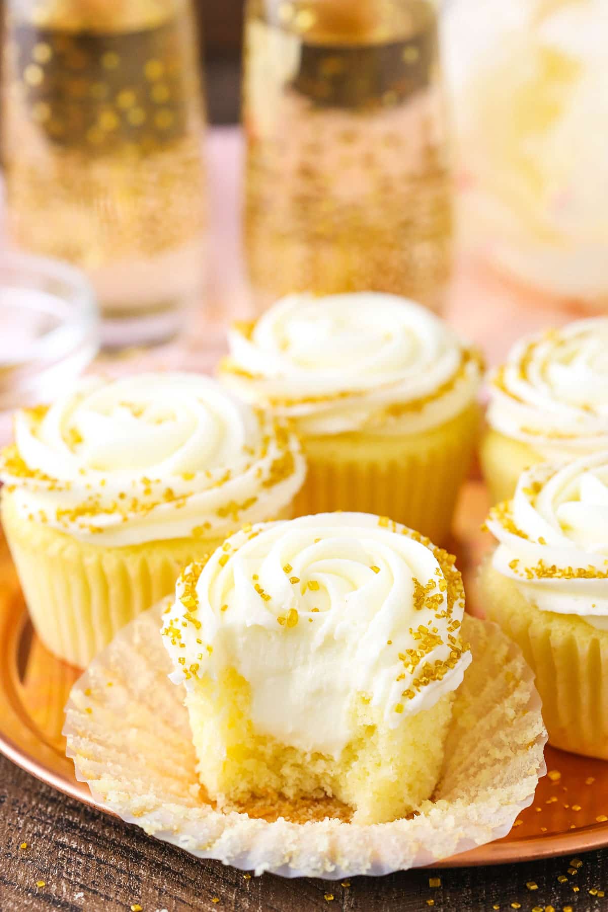 Overhead view of Champagne Cupcakes With Truffle Filling on a gold plate