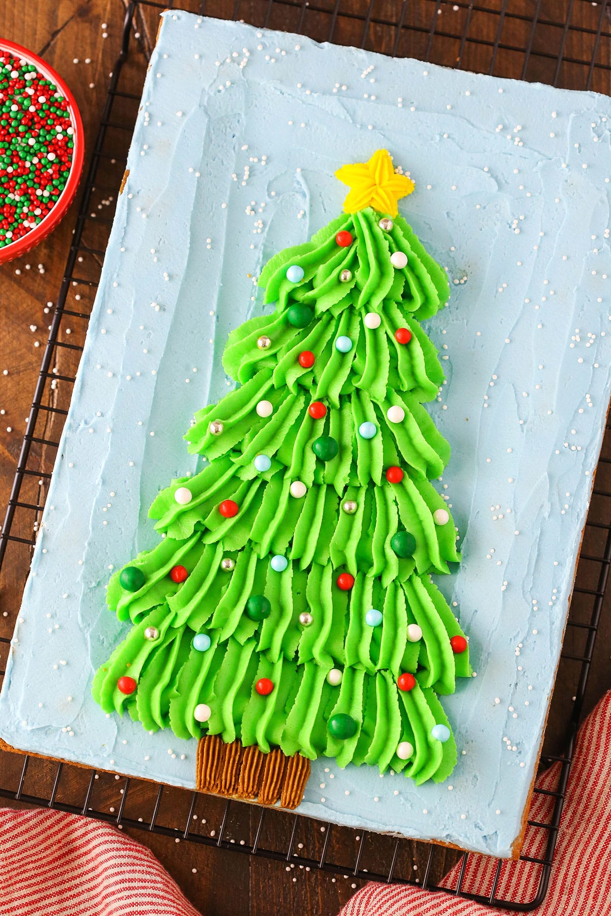 Overhead view of a Christmas Tree Chocolate Chip Cookie Cake on a black cooling rack