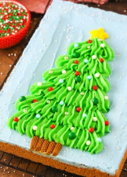 Overhead view of a Christmas Tree Chocolate Chip Cookie Cake on a black cooling rack