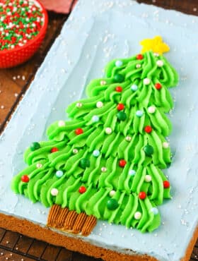 Overhead view of a Christmas Tree Chocolate Chip Cookie Cake on a black cooling rack