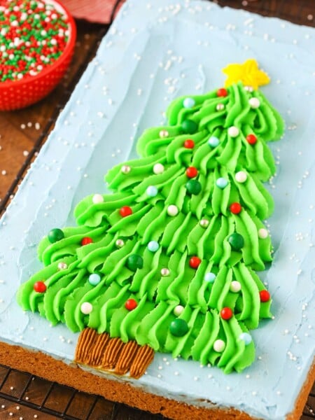 Overhead view of a Christmas Tree Chocolate Chip Cookie Cake on a black cooling rack