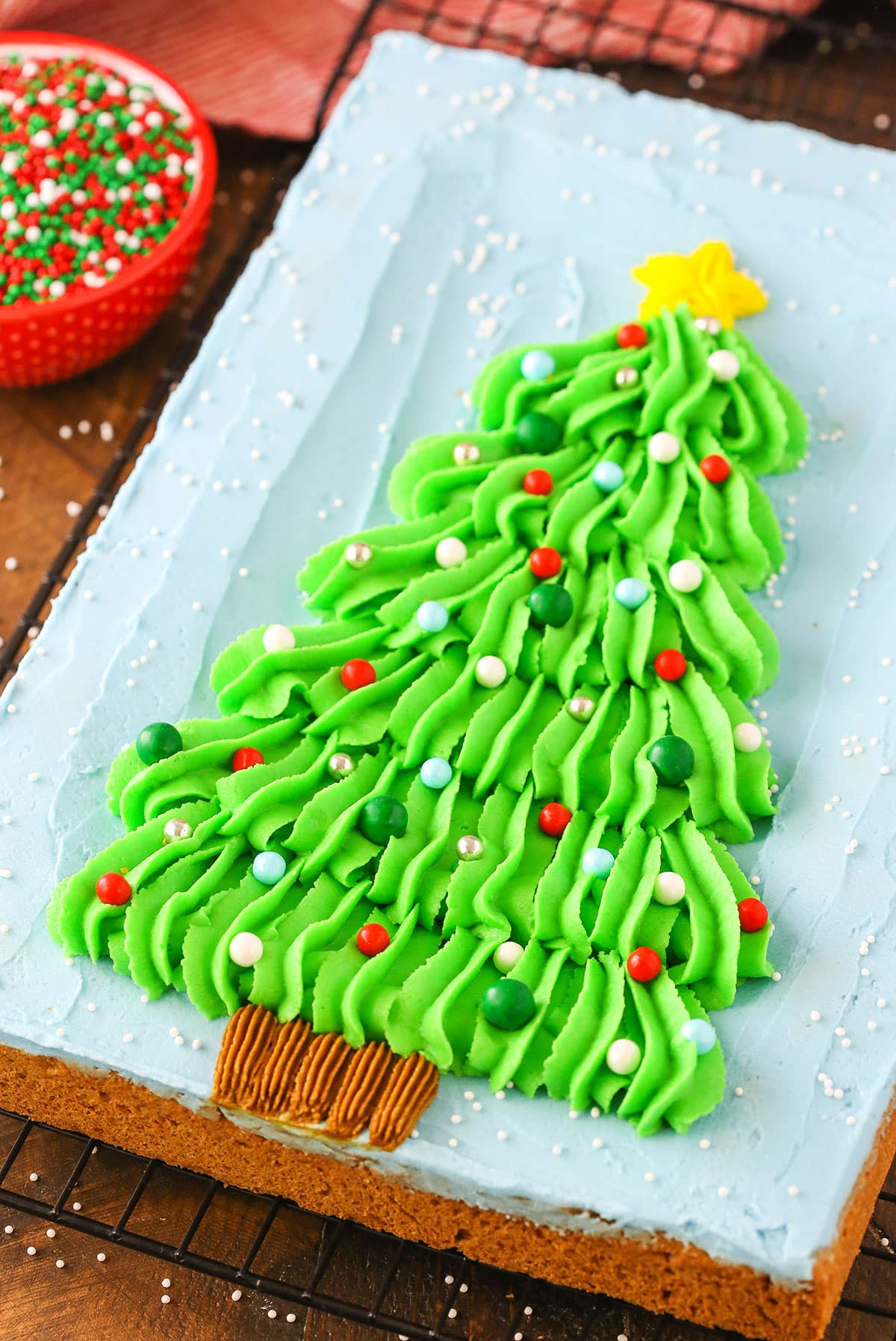 Overhead view of a Christmas Tree Chocolate Chip Cookie Cake on a black cooling rack