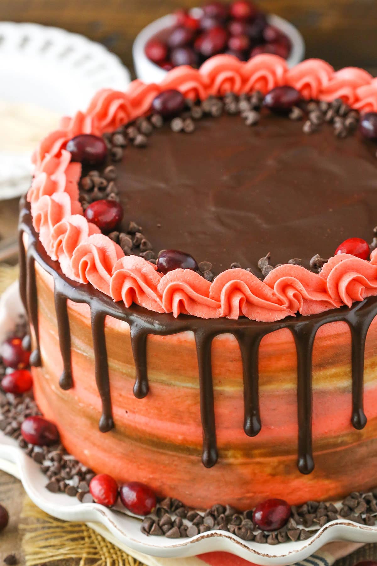 Overhead view of a Cranberry Fudge Layer Cake on a white platter