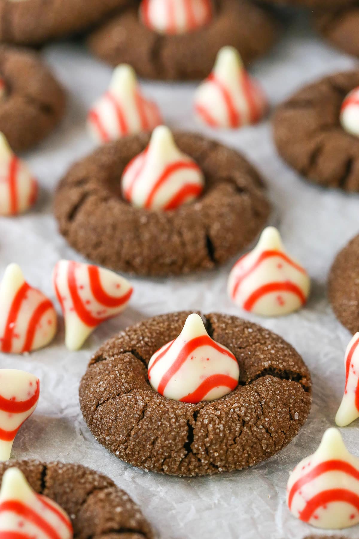 Peppermint Chocolate Thumbprint Cookies spread evenly over parchment paper