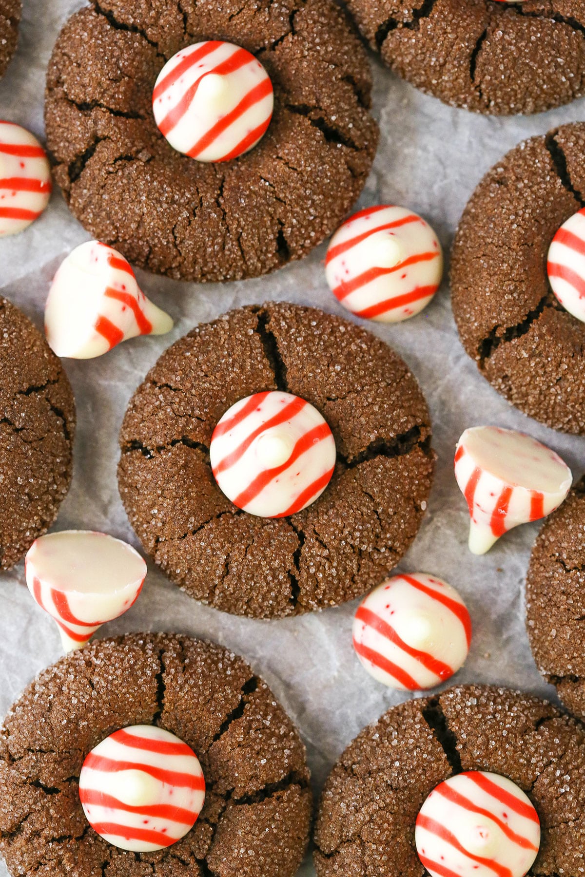 Peppermint Chocolate Thumbprint Cookies spread evenly over parchment paper