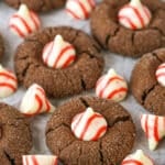 Peppermint Chocolate Thumbprint Cookies spread evenly over parchment paper