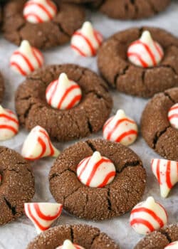 Peppermint Chocolate Thumbprint Cookies spread evenly over parchment paper