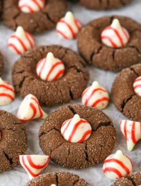 Peppermint Chocolate Thumbprint Cookies spread evenly over parchment paper