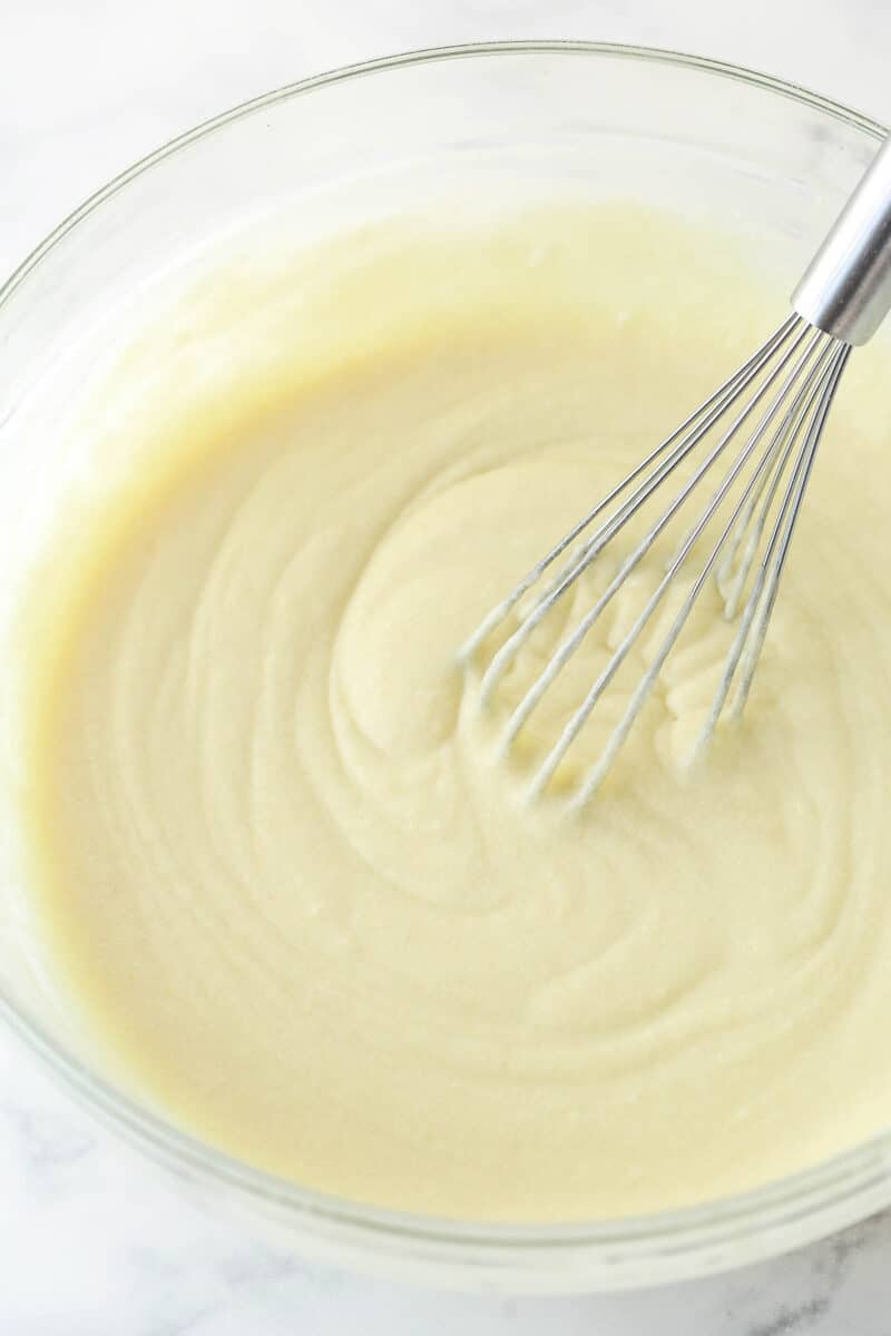 Whisking dry ingredients into wet ingredients for vanilla cupcake batter.