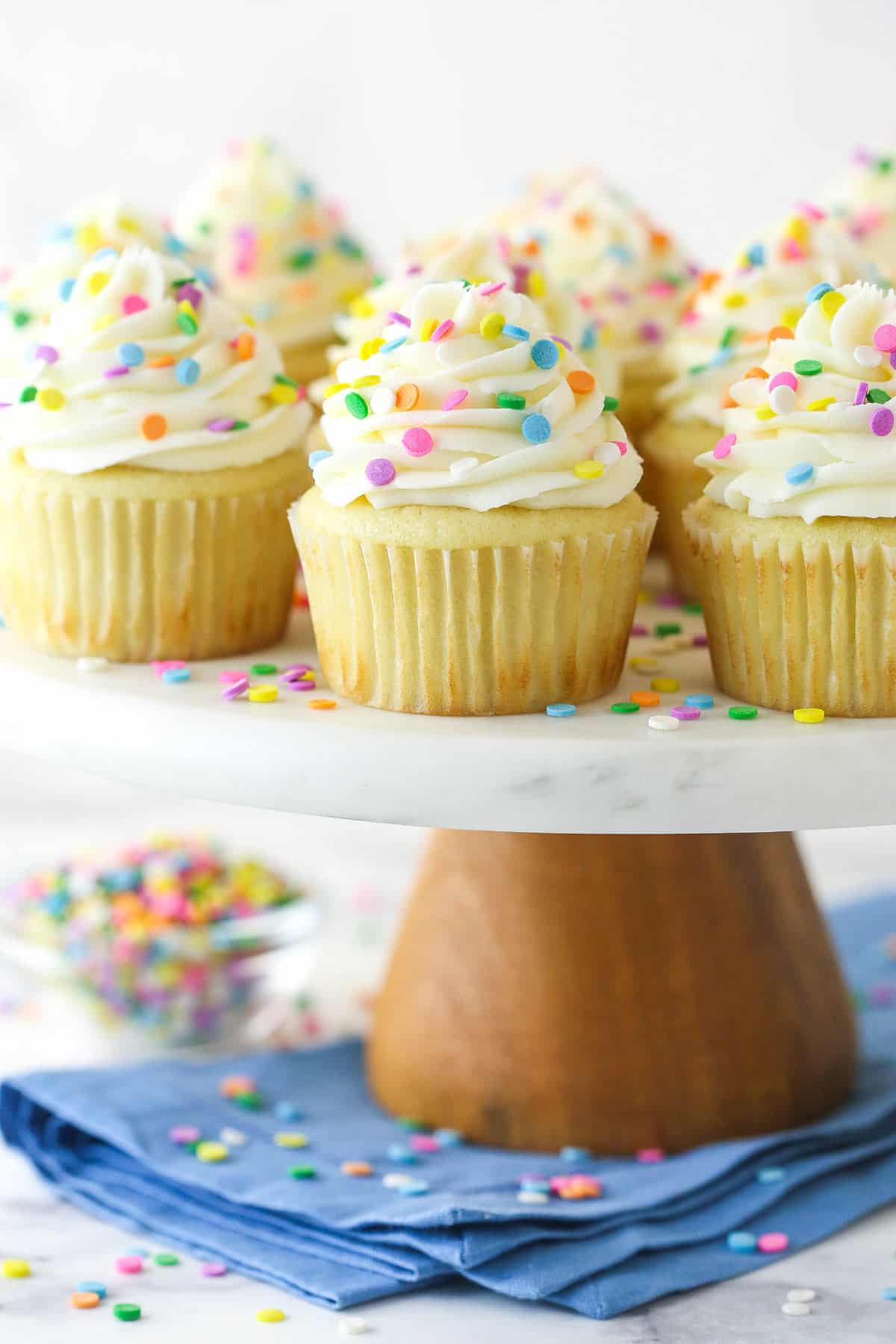 Vanilla cupcakes on a cupcake stand.