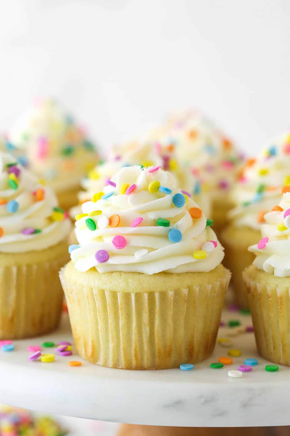 Closeup of vanilla cupcakes on a cupcake stand.