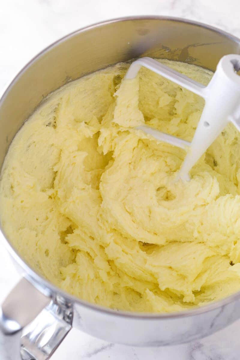 Creaming together butter, sugar, and eggs for pumpkin loaves.