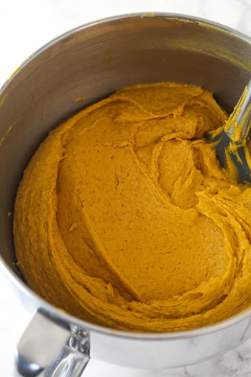 Combing wet and dry ingredients for pumpkin bread.