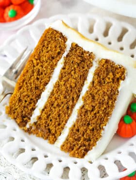 A slice of pumpkin layer cake on a plate.