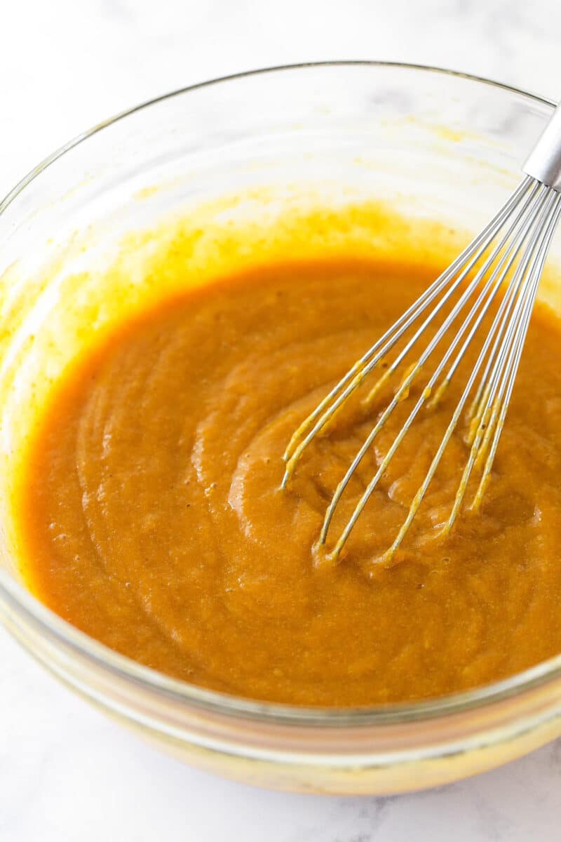 This classic pumpkin pie recipe is so easy and delicious! Full of pumpkin flavor and fall spices, it's the perfect Thanksgiving dessert. Whisking together the pumpkin puree, eggs and light brown sugar.