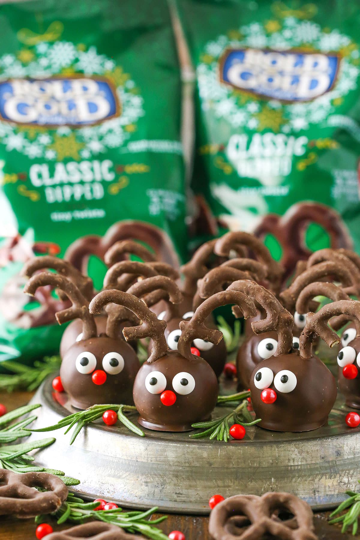 Side view of Reindeer Cookie Balls on a gray platter with Rold Gold Classic Dipped Pretzels in the background