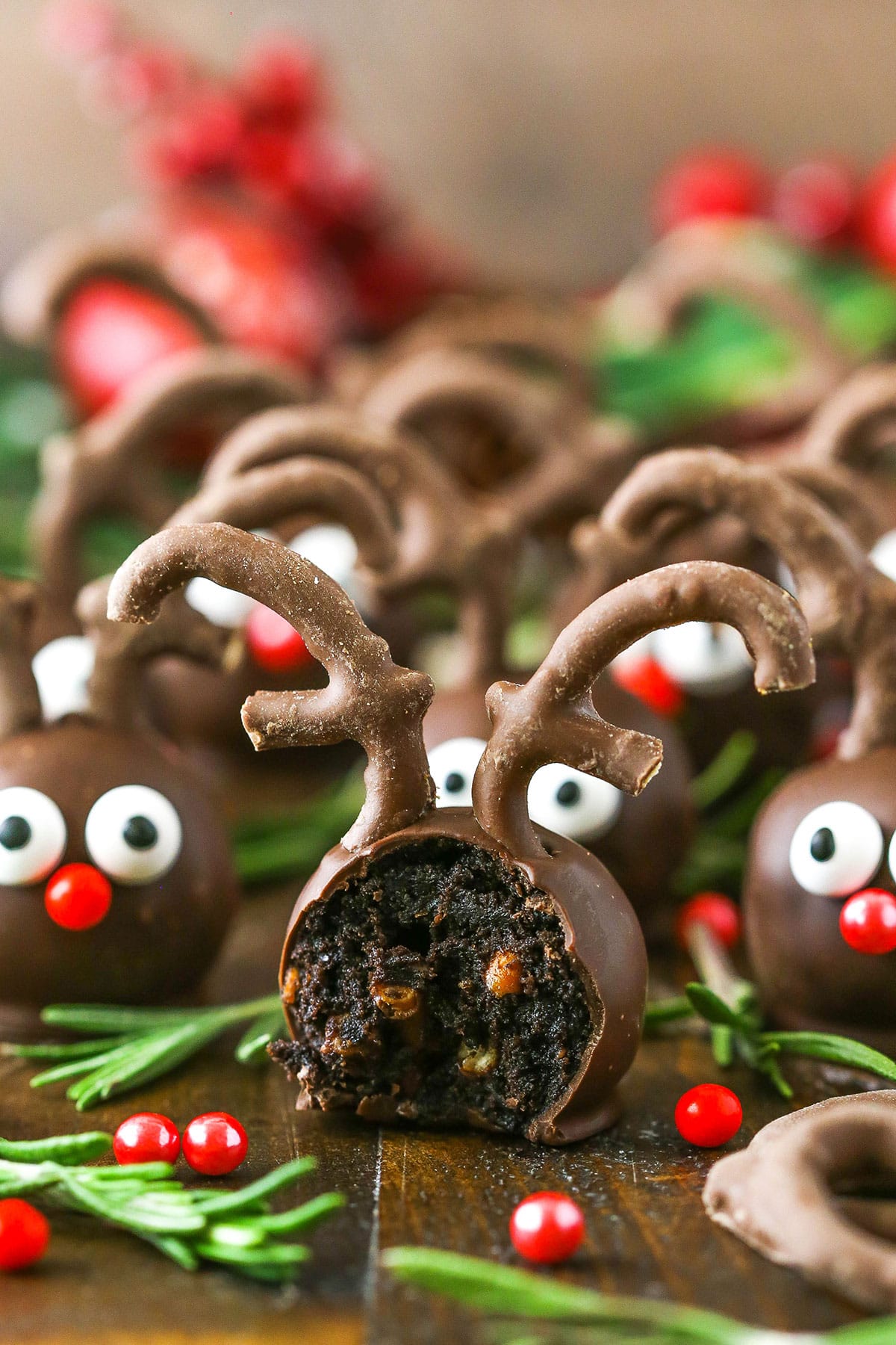 Side view of a Reindeer Cookie Ball with a bite removed on a wooden table