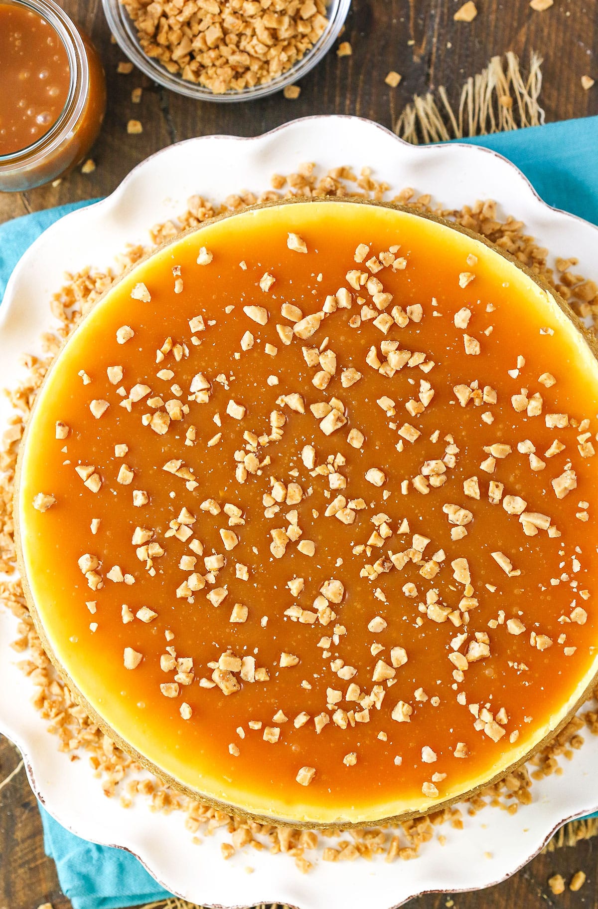 Overhead view of a Salted Caramel Cheesecake on a white serving platter