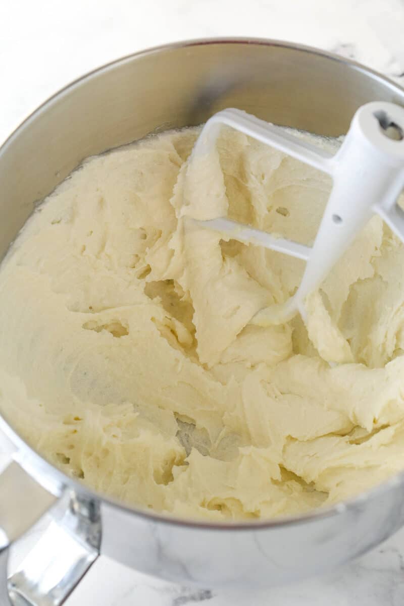 Creaming together butter, oil, sugar, and vanilla for cake batter.