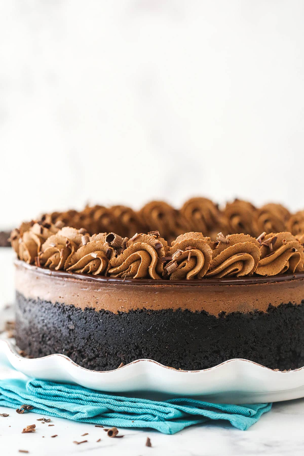 Side view of chocolate cheesecake on a serving platter.