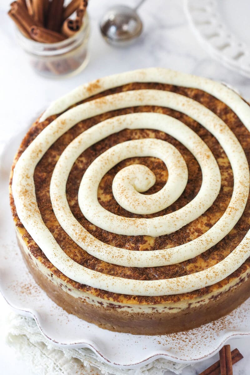 Overhead image of cinnamon roll cheesecake on a serving plate.