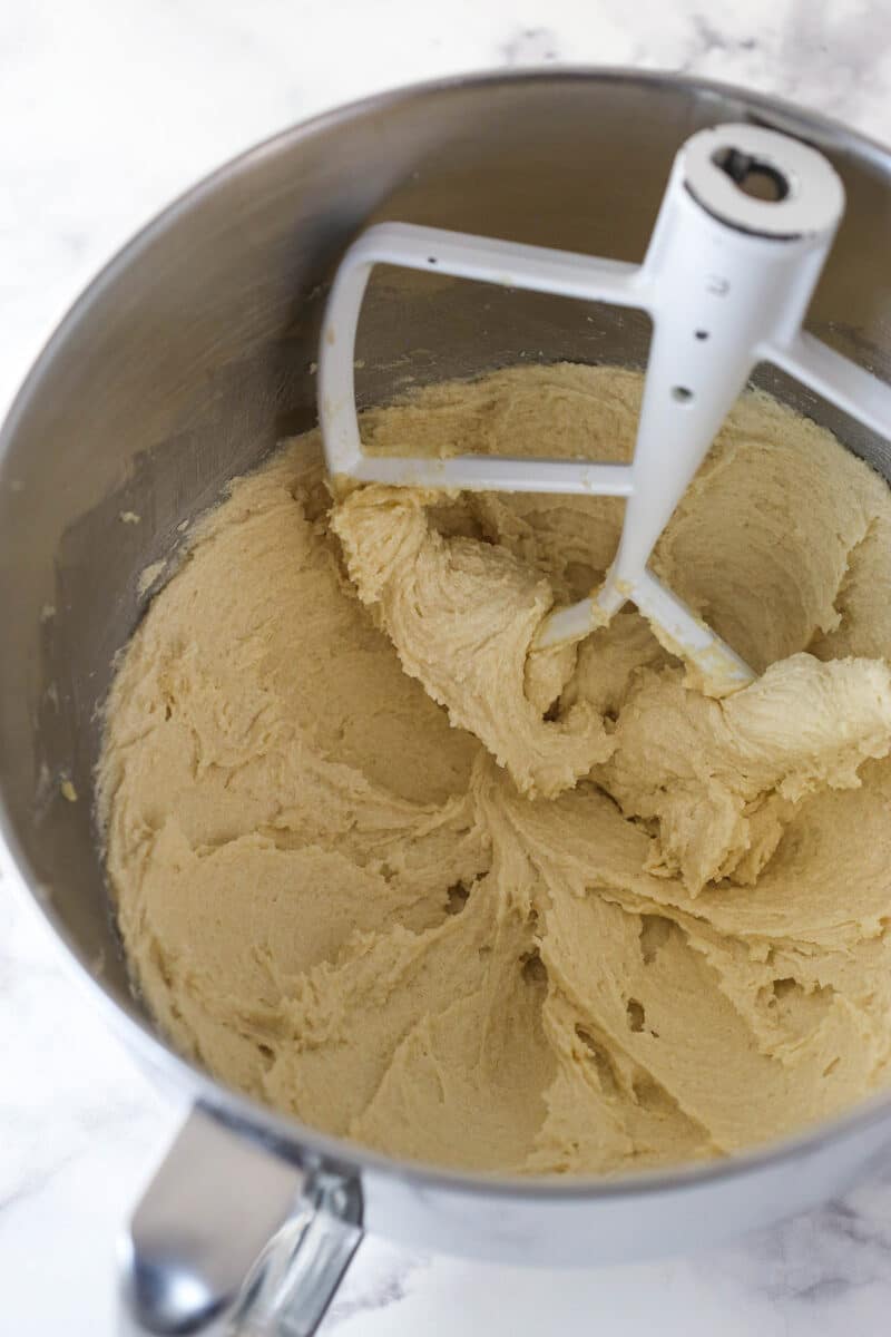 Overhead view of a silver mixing bowl of creamed butter and sugar.