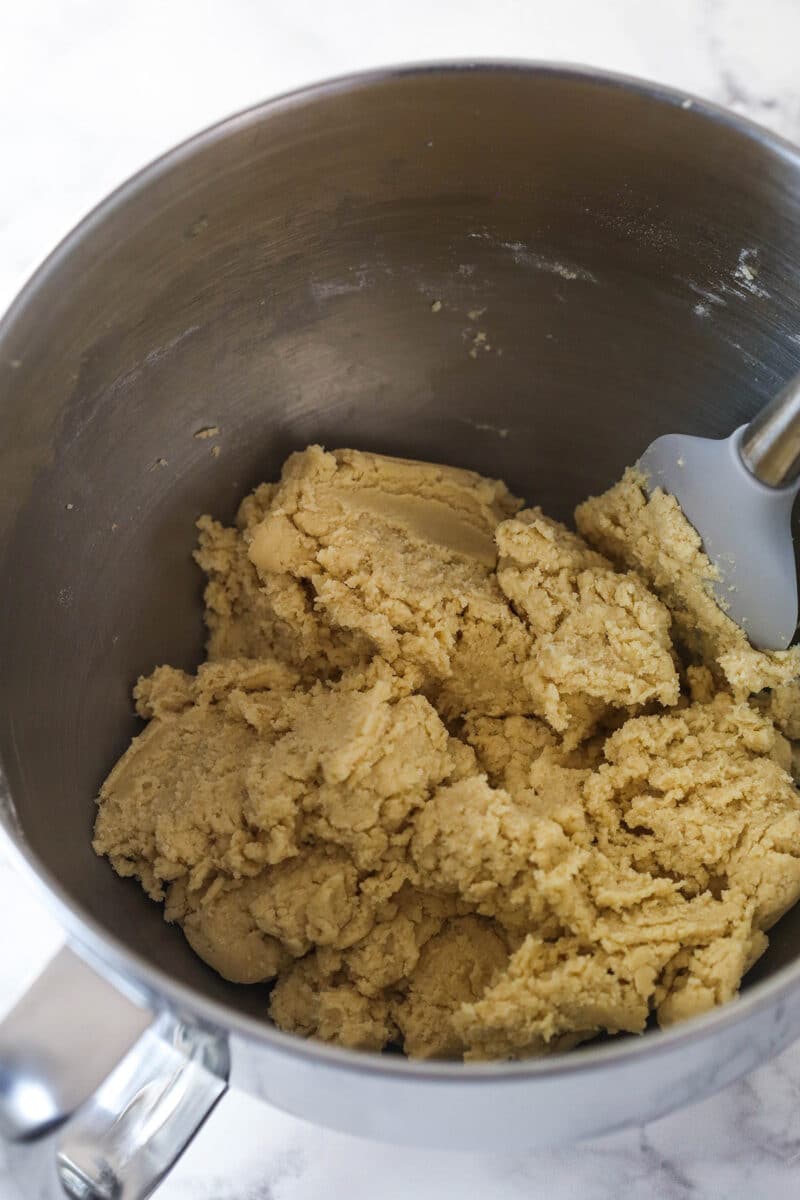 Overhead view of a silver mixing bowl with prepared dough.