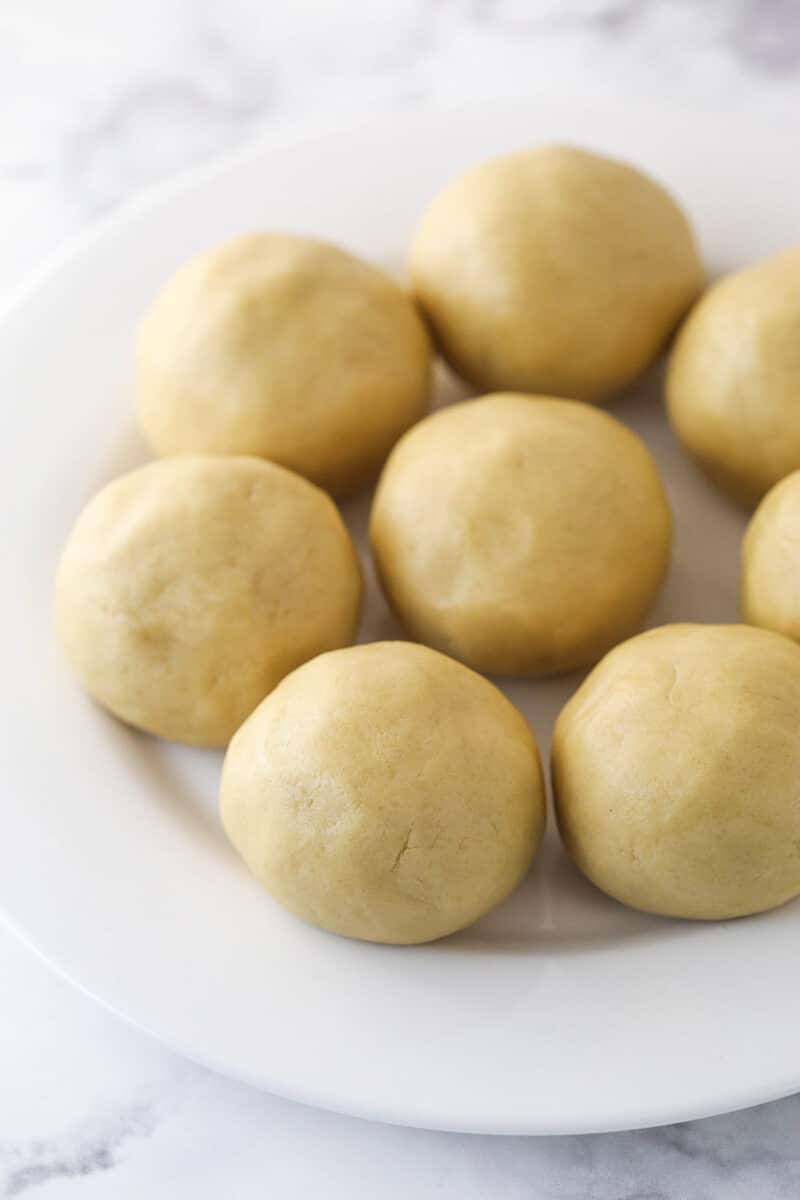 A white plate holding cookie balls.